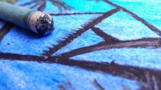 Close-up of a child's crumpled drawing next to its sleek, professionally illustrated version.