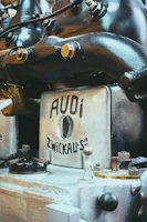 Professional mechanic inspecting an Audi engine with precision tools