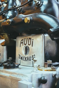 Close-up of a mechanic inspecting an Audi transmission system.