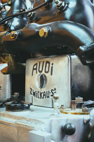 Close-up of a mechanic using advanced diagnostic equipment on an Audi engine.