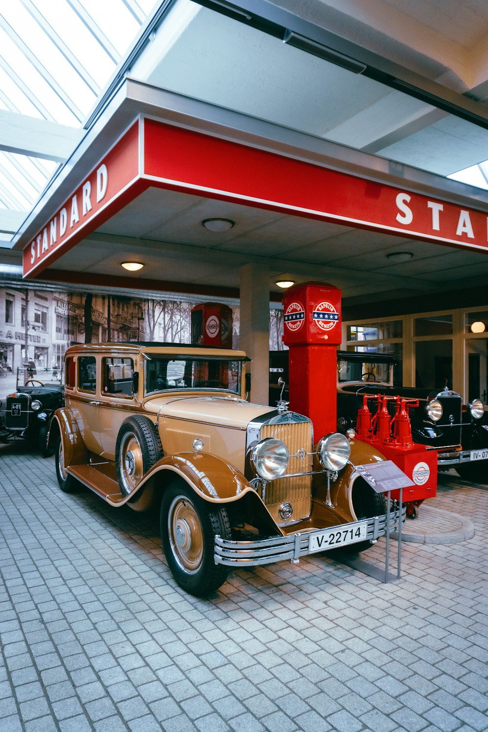 a vintage car is parked in front of a station