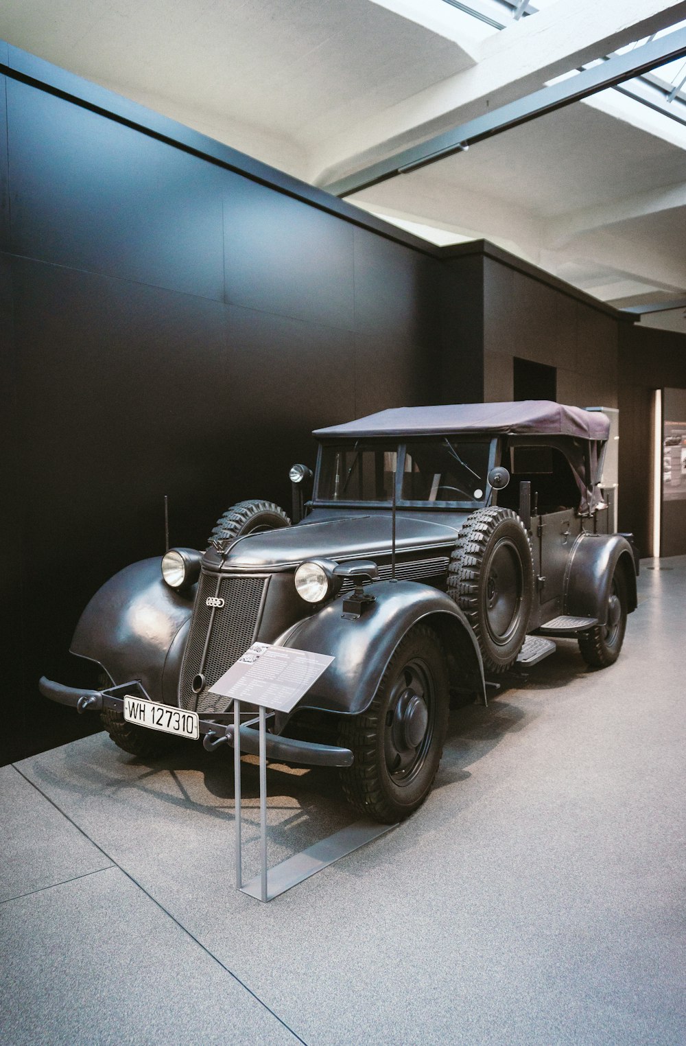 an antique car is on display in a museum