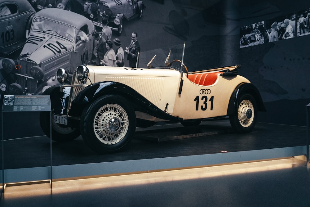 an old model car on display in a museum