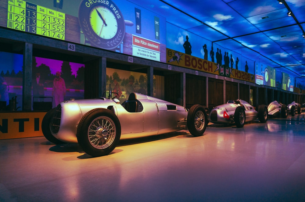 a row of race cars on display in a museum