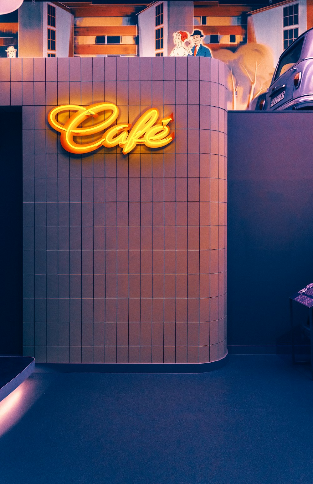 a neon sign that reads cafe on the side of a building