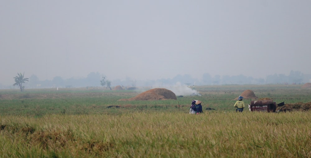 a couple of people that are standing in a field