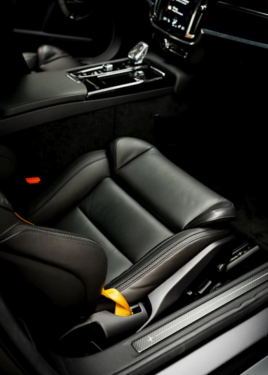 A sleek black car dashboard illuminated with yellow accents, reflecting the stylish theme of Karisma Motor.