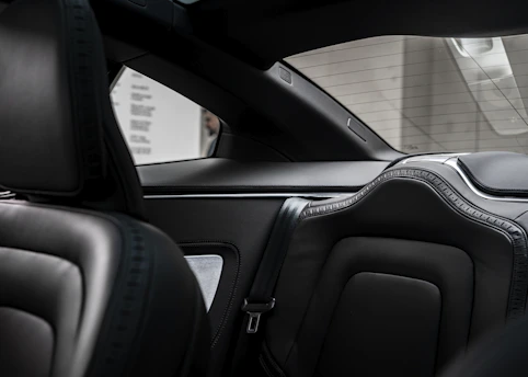 Interior view of a spacious limo with plush leather seats driving toward LaGuardia Airport.