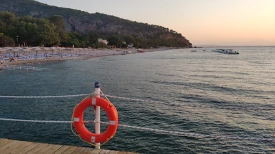 Sunset view over the calm sea with scuba tanks lined up on the beach.