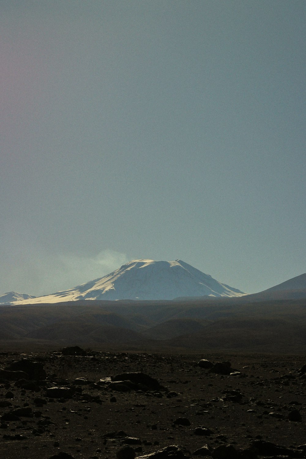 a snow covered mountain in the distance on a clear day