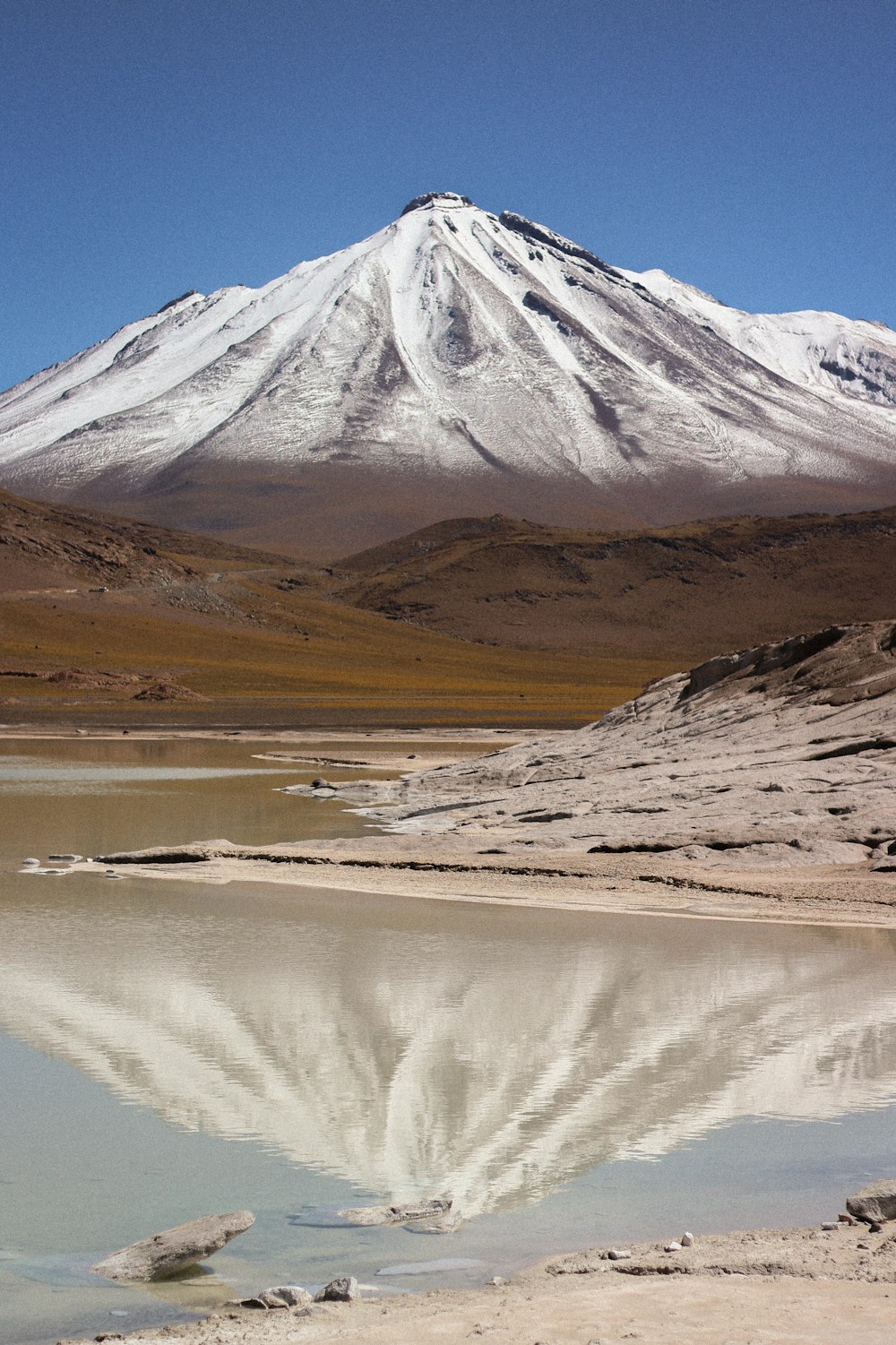 a mountain with a snow covered peak in the background