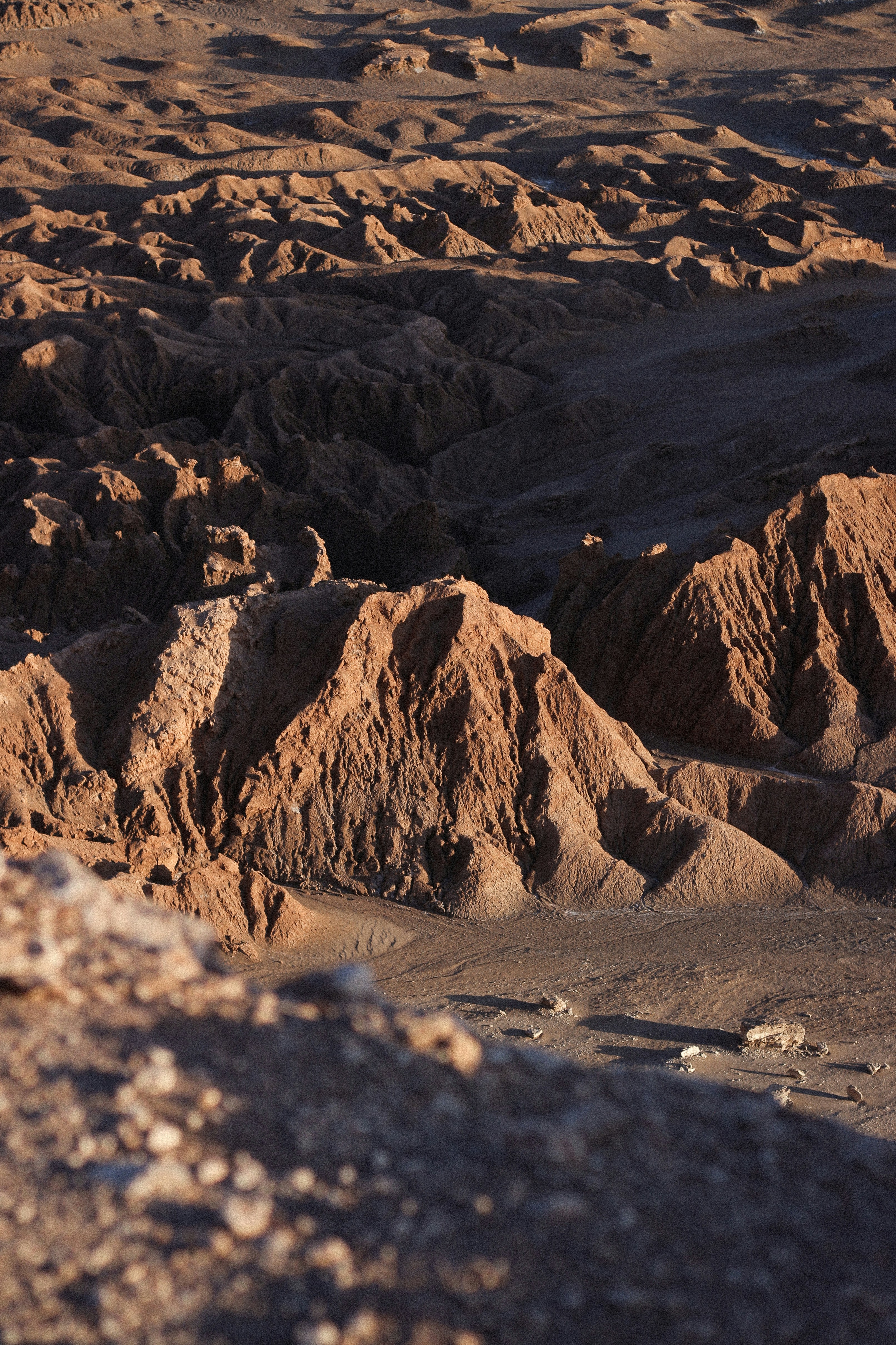 a man riding a horse on top of a rocky hillside
