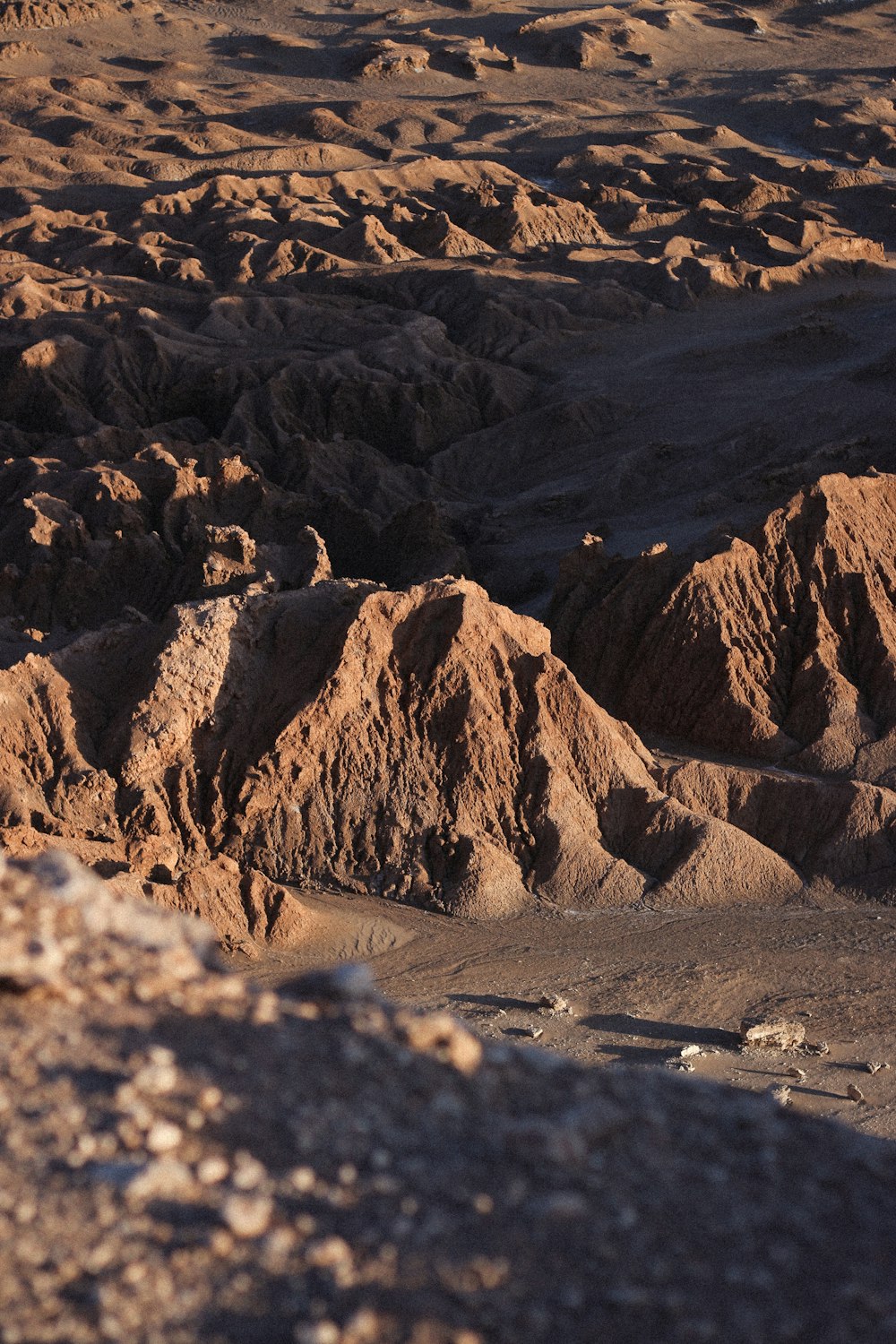 a man riding a horse on top of a rocky hillside