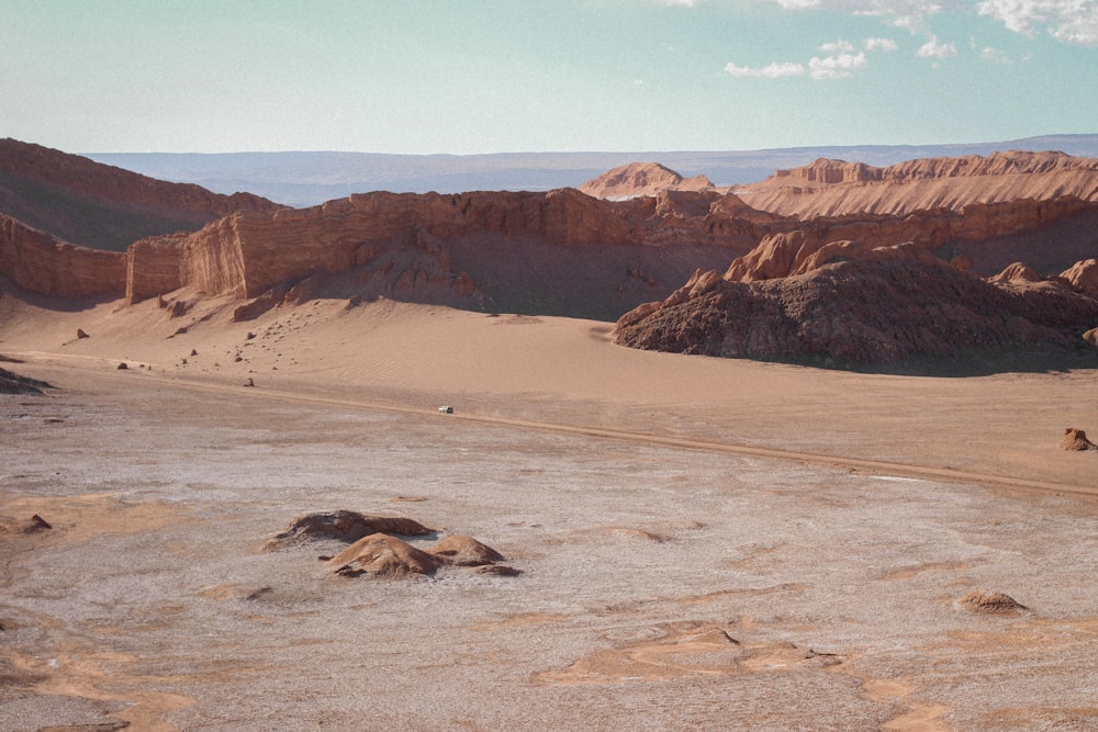 a group of people riding horses in the desert