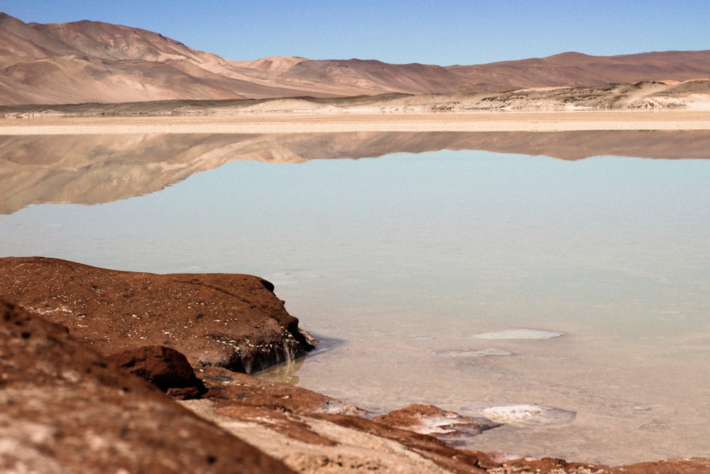 Un grande specchio d'acqua circondato da montagne