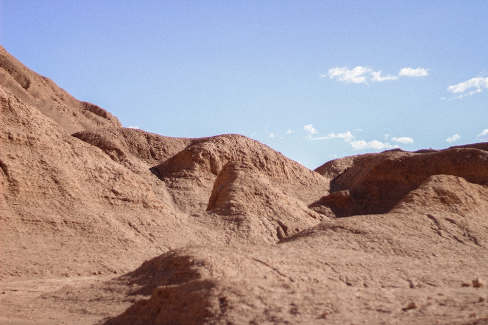 a large pile of dirt sitting in the middle of a desert