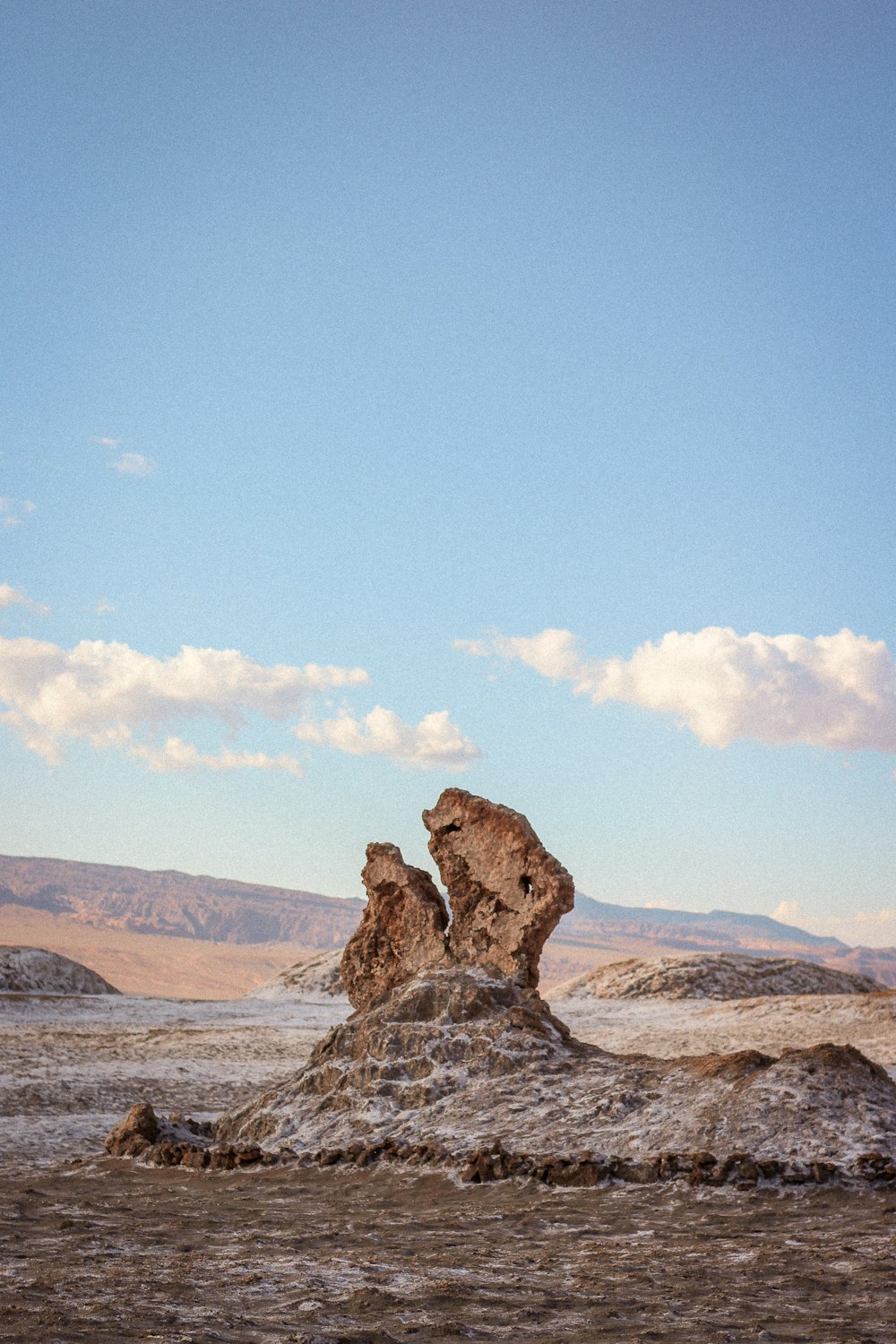 a large rock formation in the middle of a desert