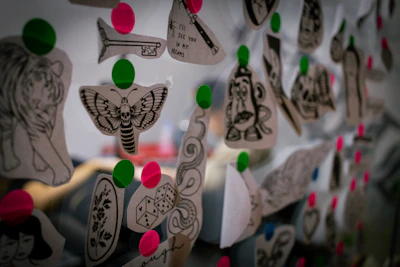 A collection of tattoo designs displayed on a wall.