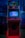 An arcade cabinet with a red and black design is placed indoors. The screen displays a fighting game, and the control panel has joysticks and buttons. The top of the cabinet has a sign with the words 'DIVIRTA-SE' in bold letters.