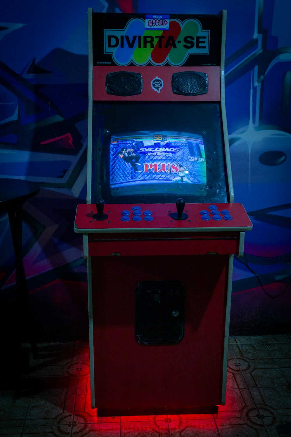 a video game machine sitting on top of a tile floor