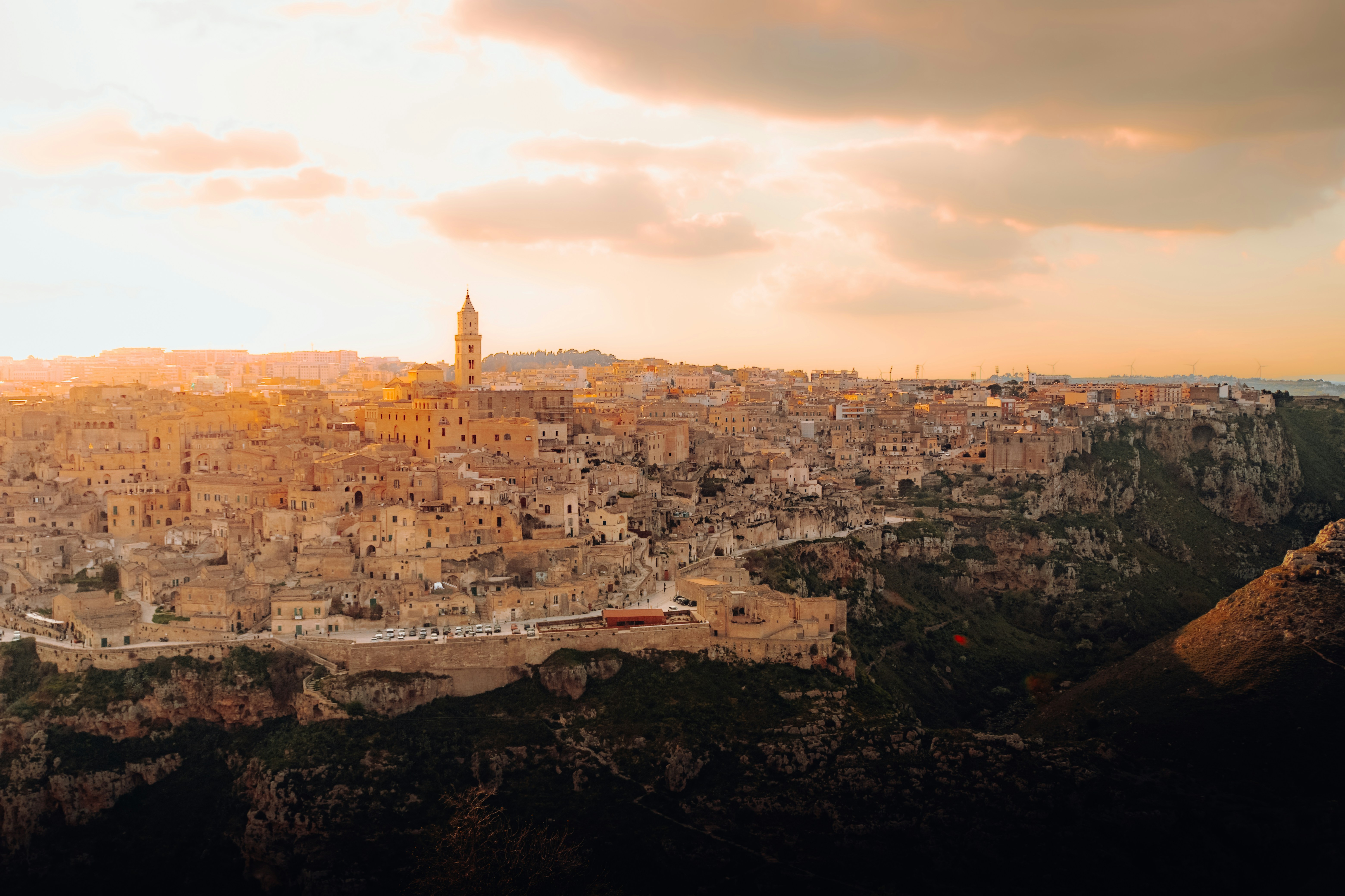 a view of a city from a high point of view, Sassi of Matera during Sunset, Italy! 🇮🇹