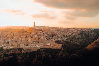 A panoramic view of an ancient Middle Eastern city at sunset.