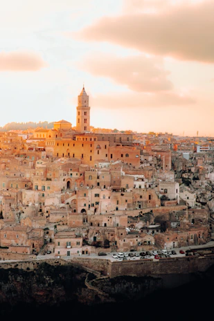 Ancient Mesopotamian cliff bathed in golden sunset light, evoking mystery and history.