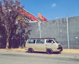 Mobile auto glass service van parked beside a customer's car.