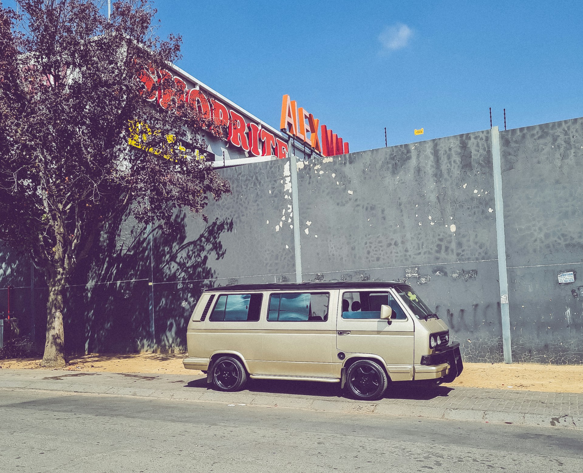 woman wearing yellow long-sleeved dress under white clouds and blue sky during daytime