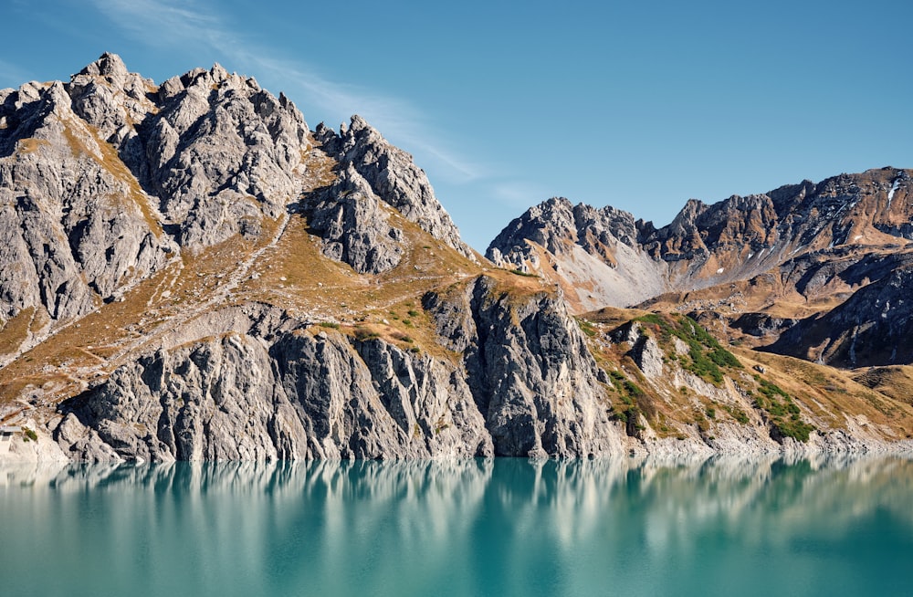 a mountain range with a body of water in front of it