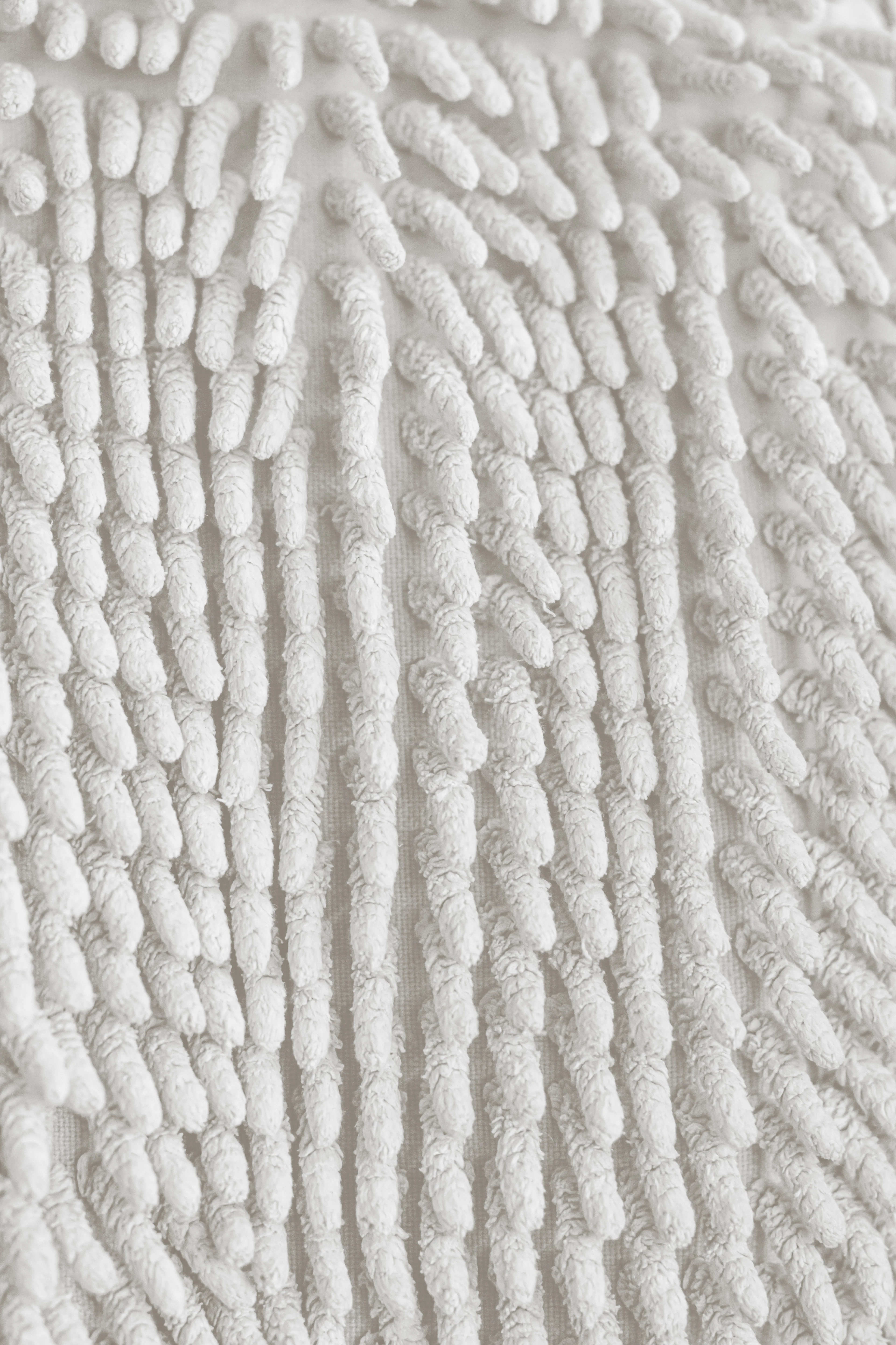 Close-up of white chenille bath mat