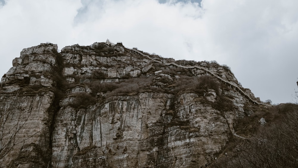 a very tall mountain with a sky in the background