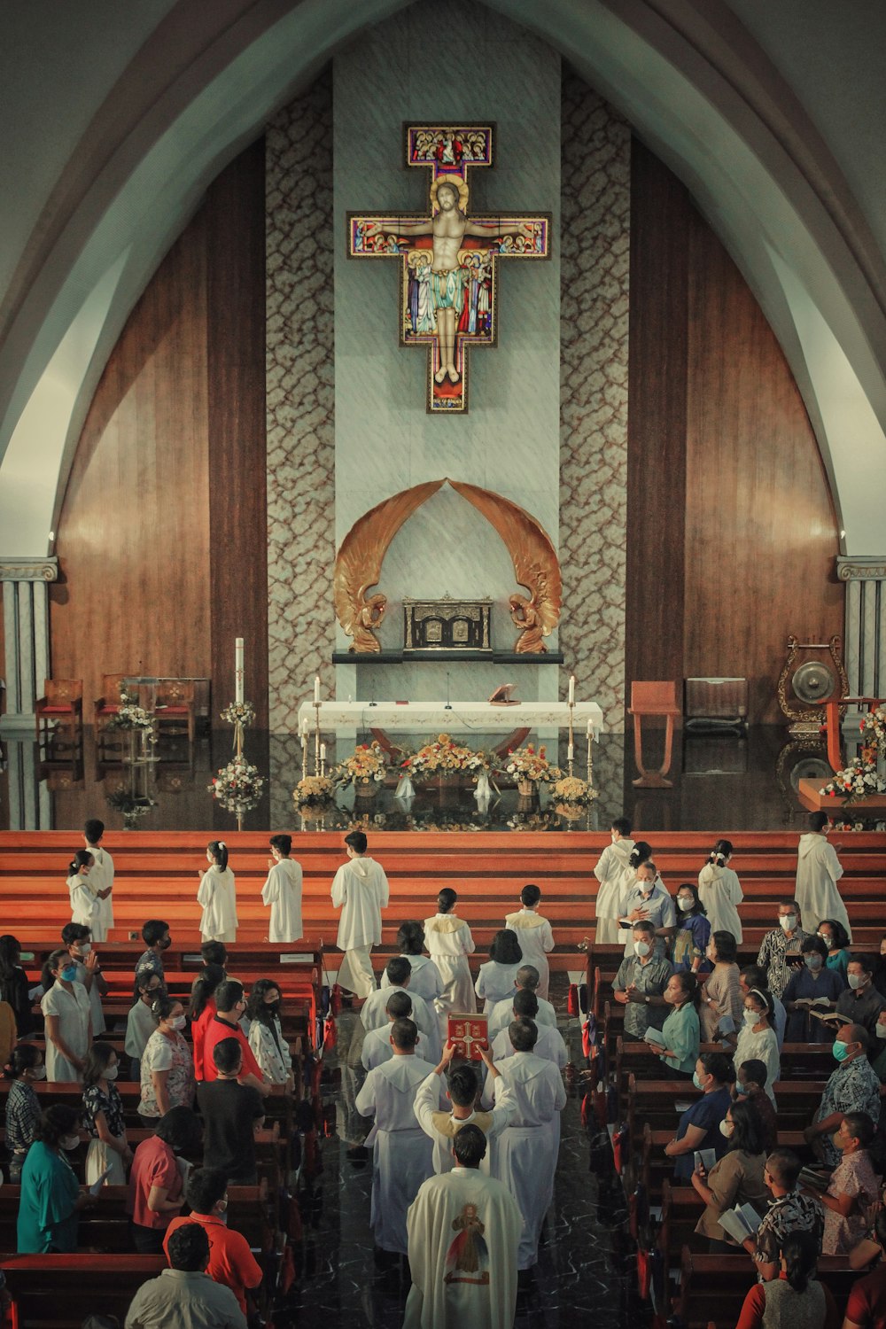 a group of people standing in front of a church alter