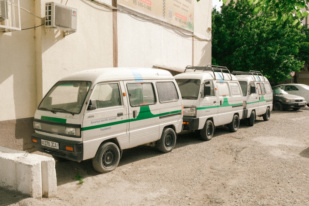 a row of vans parked on the side of a road