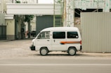 A delivery van from easy bat unloading construction materials at a busy building site.
