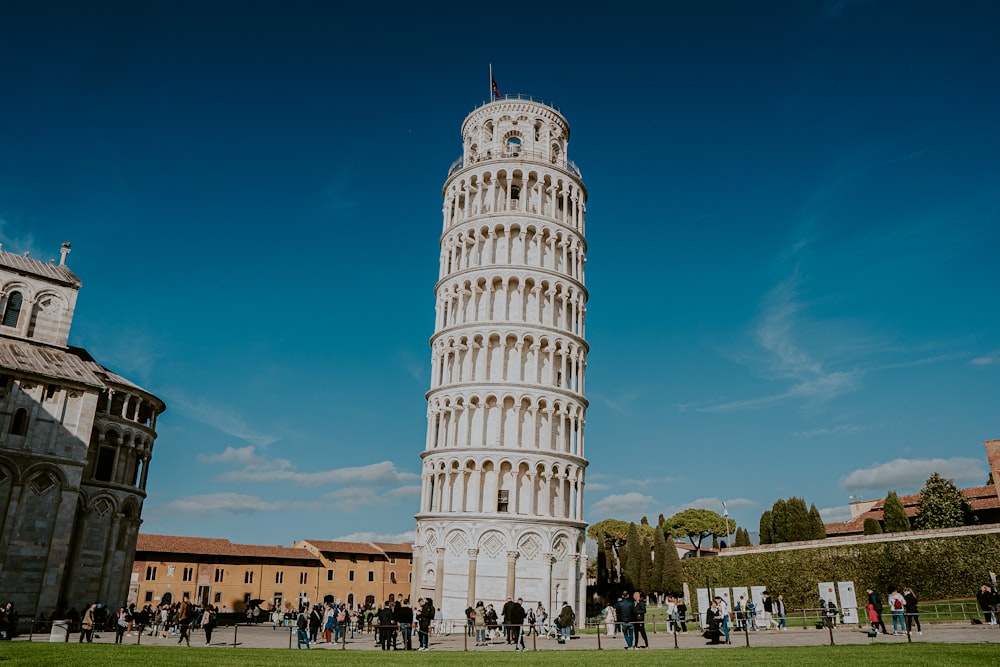 a tall white tower with a clock on it's side