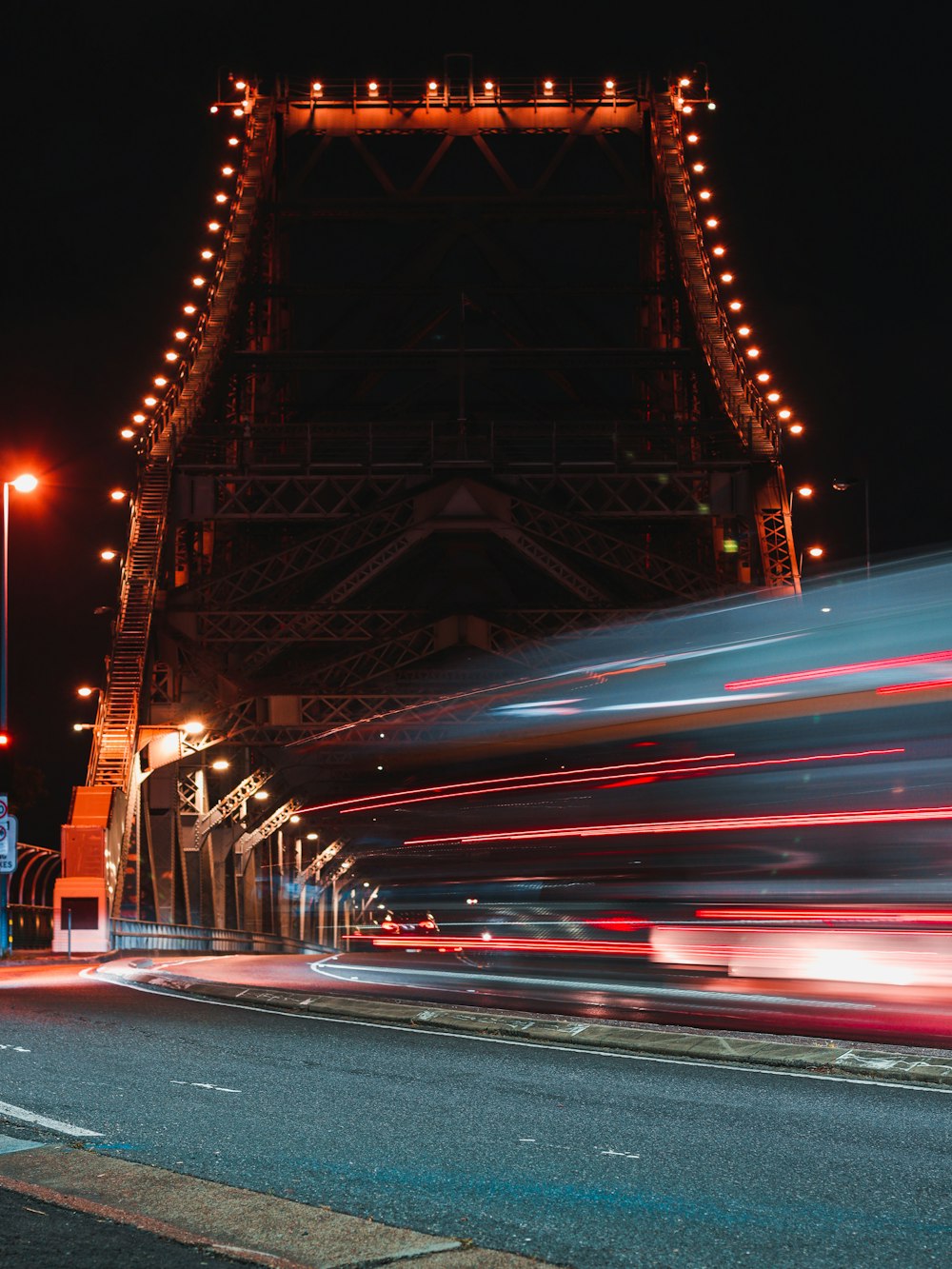 a long exposure photo of a bridge at night