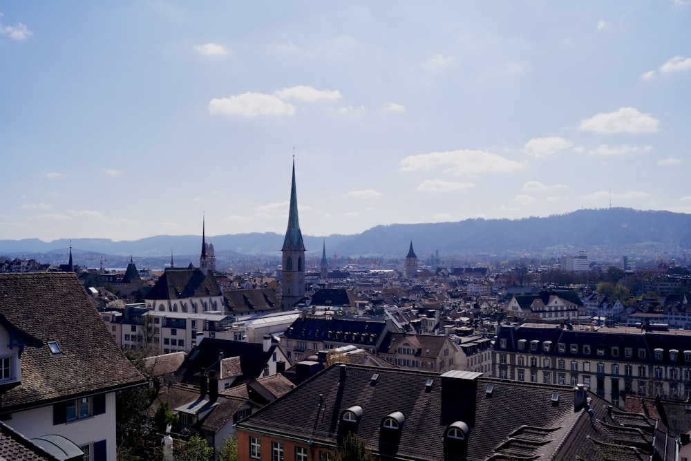 a view of a city with a church steeple in the background