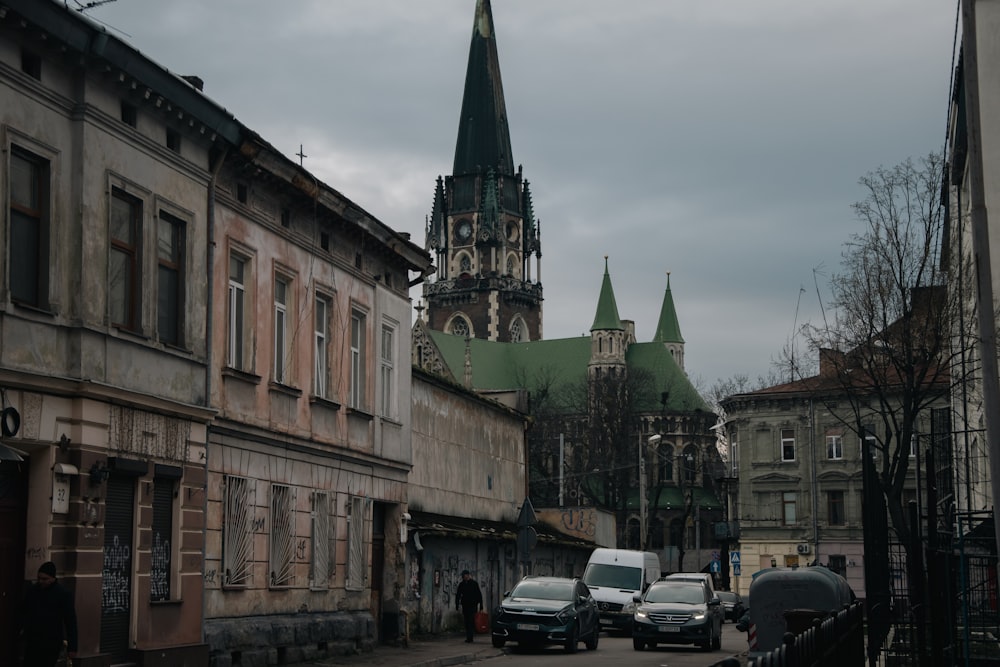 a city street with a church steeple in the background