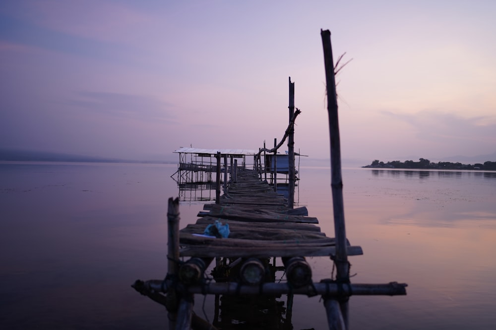 a wooden dock sitting in the middle of a body of water