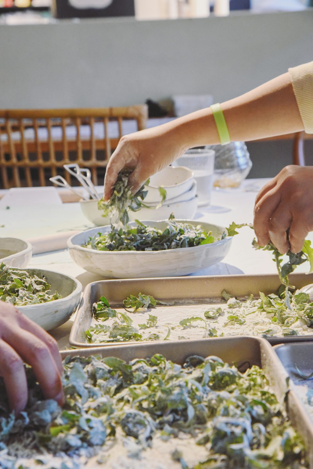 a group of people preparing food on top of a table