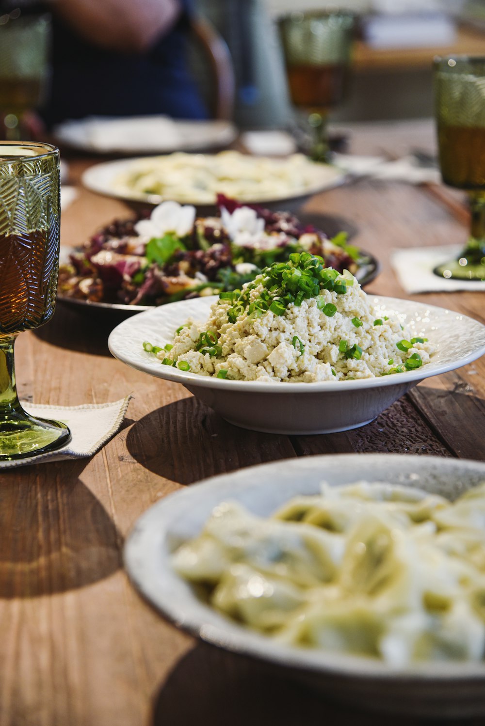 a wooden table topped with plates of food