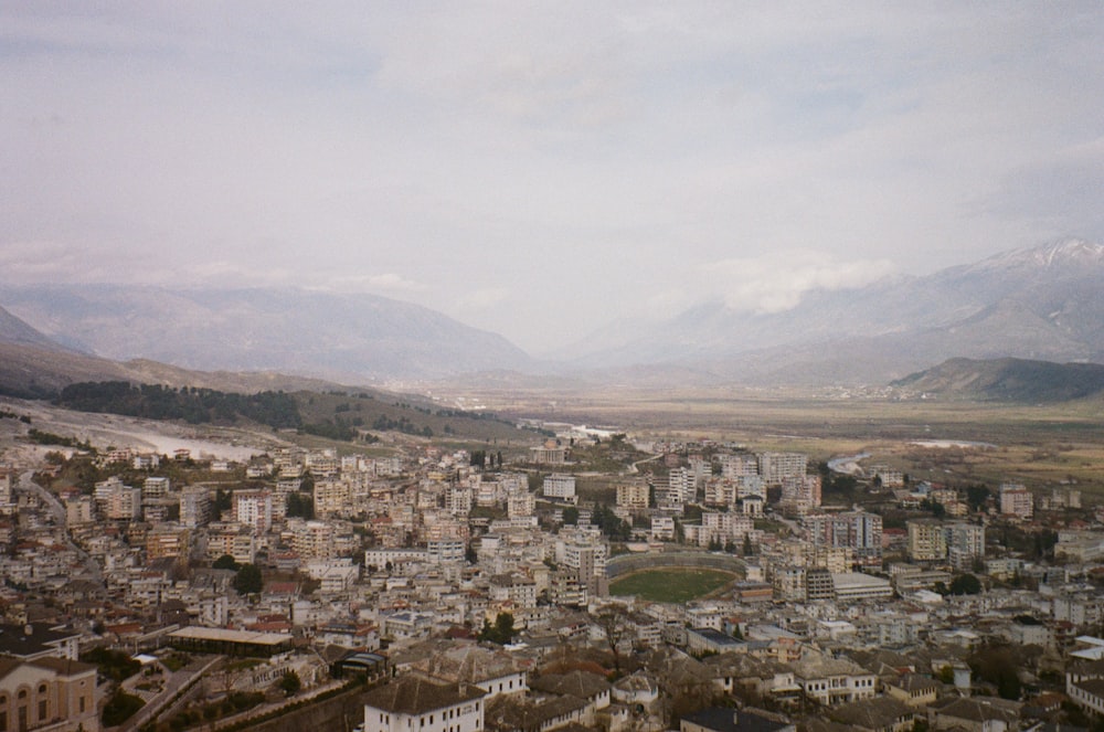 a view of a city with mountains in the background