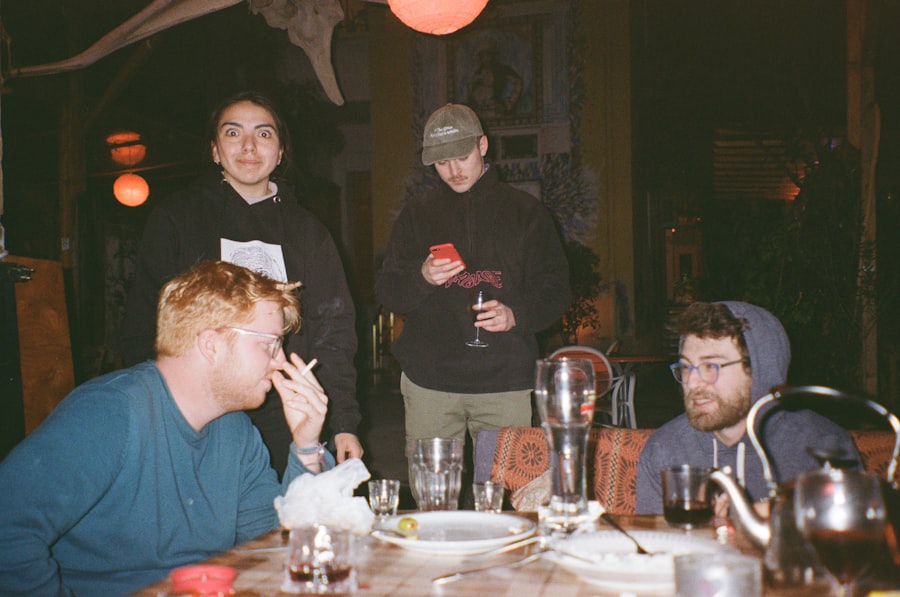 Group at table in hostel common room at night