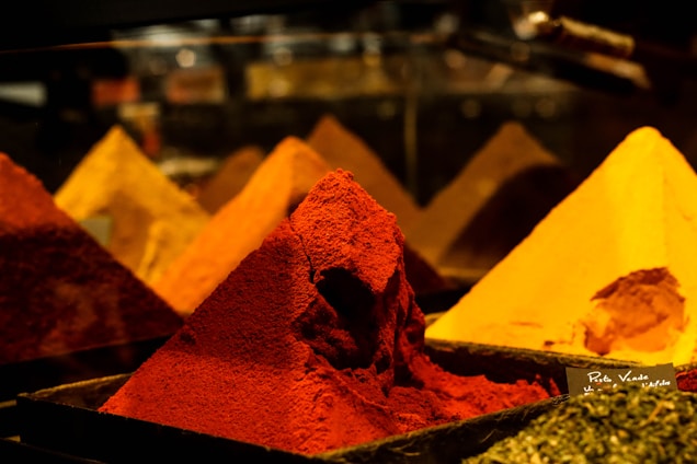 a variety of different colored powders in bins
