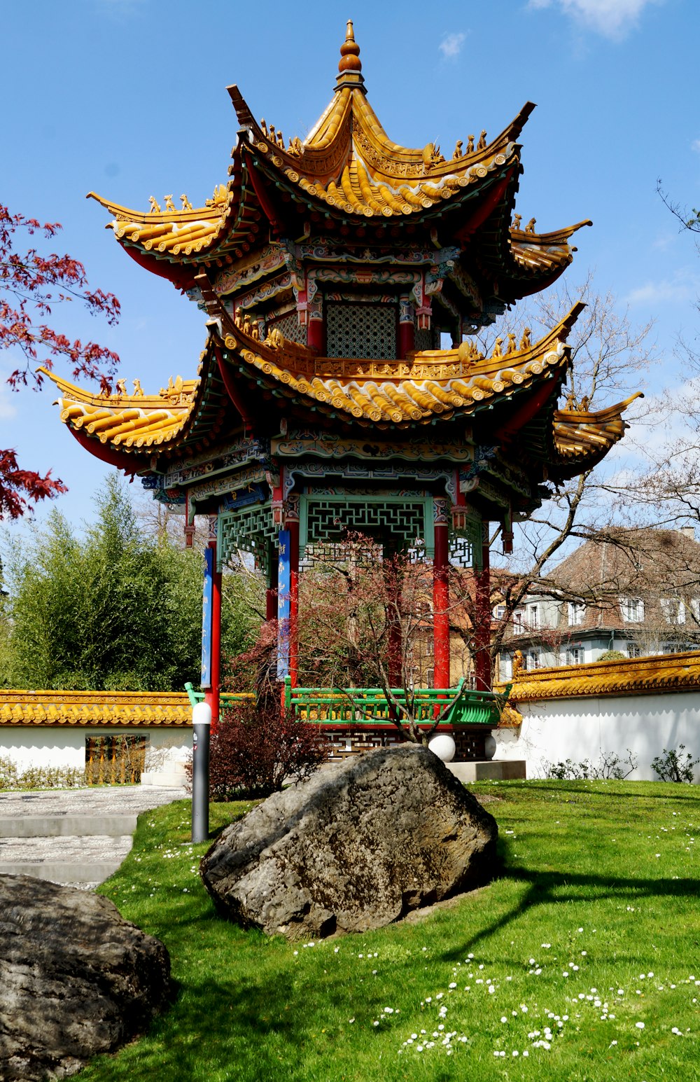 a pagoda in the middle of a grassy area