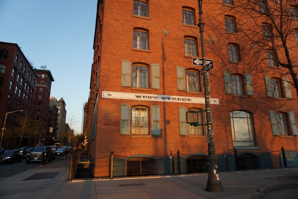 a tall brick building with a street sign in front of it