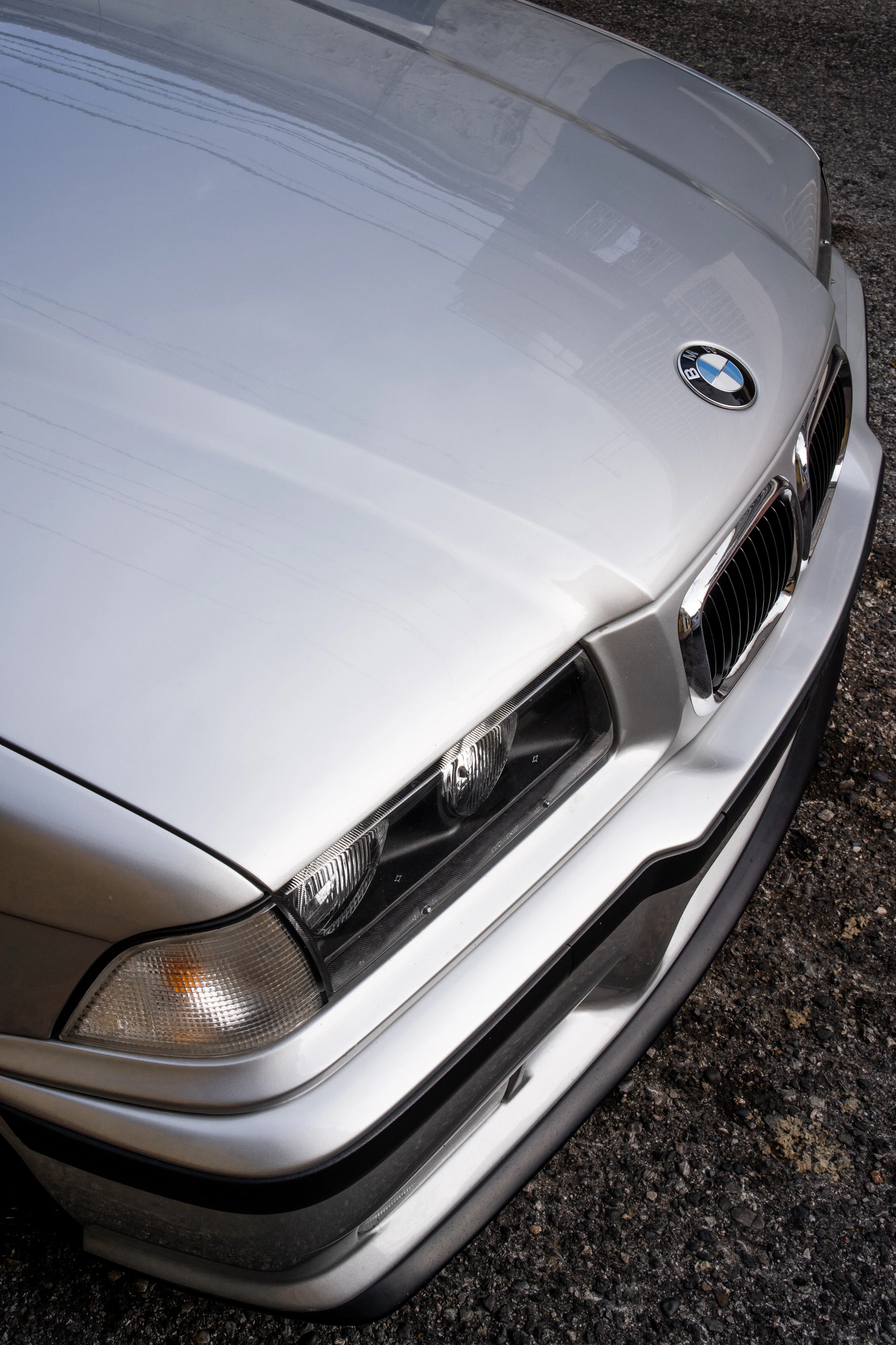 a close up of the front of a silver car