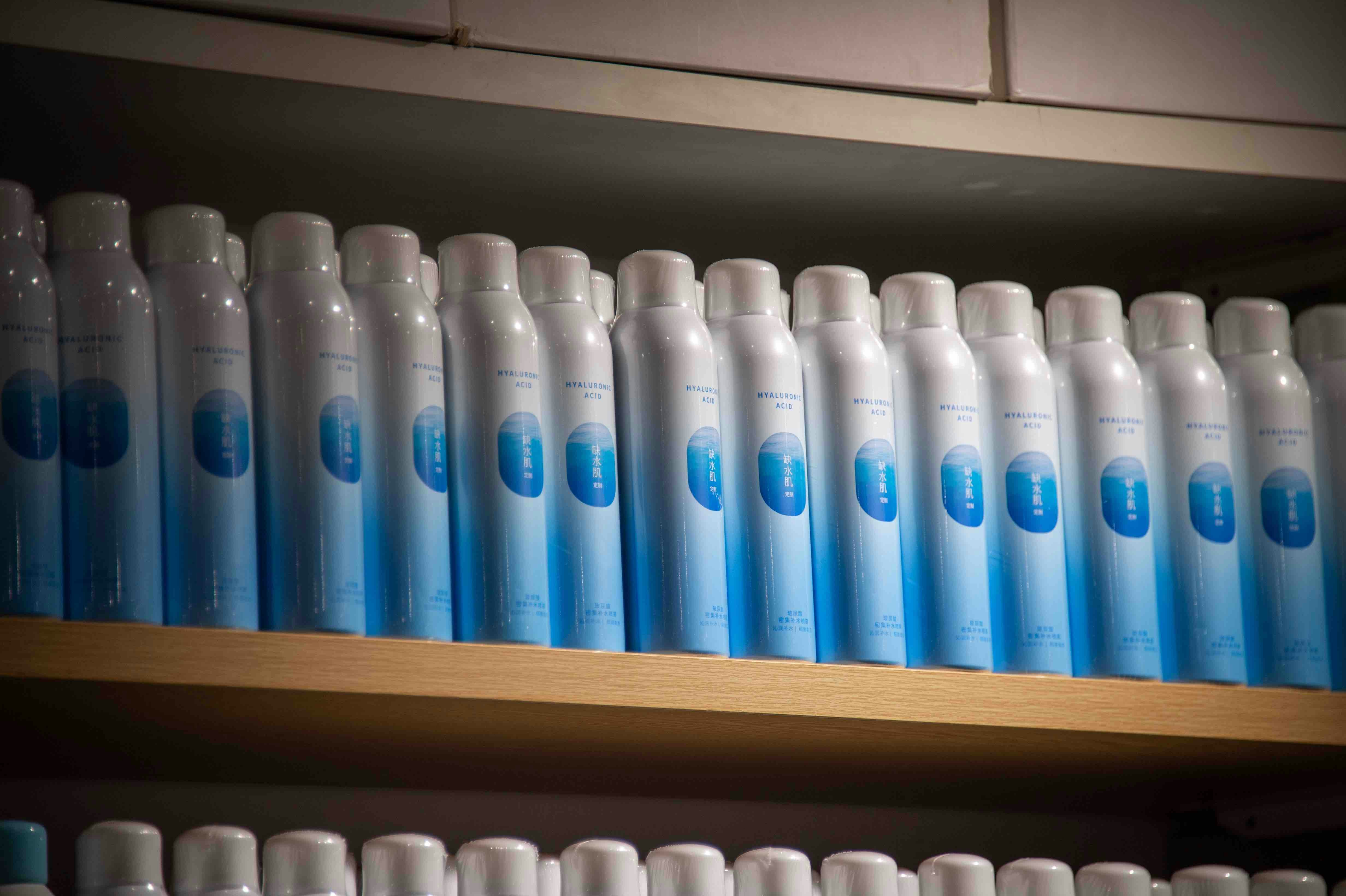 a row of blue and white bottles on a shelf
