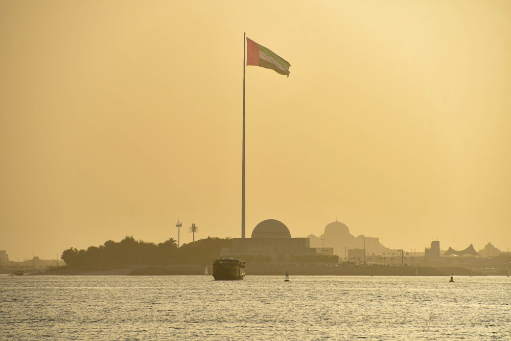 a boat in a body of water with a flag on top of it